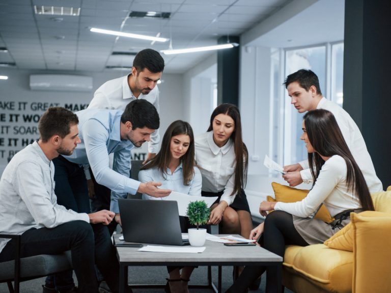 guy-shows-document-girl-group-young-freelancers-office-have-conversation-working